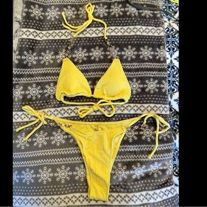 Never worn! Yellow bikini with a chain/rhinestone side and on the top! So cute!